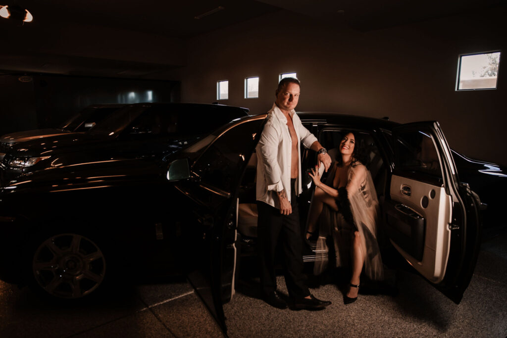 Bold and enticing boudoir image with car, evoking a sense of luxury and romance of couple in Carefree, AZ